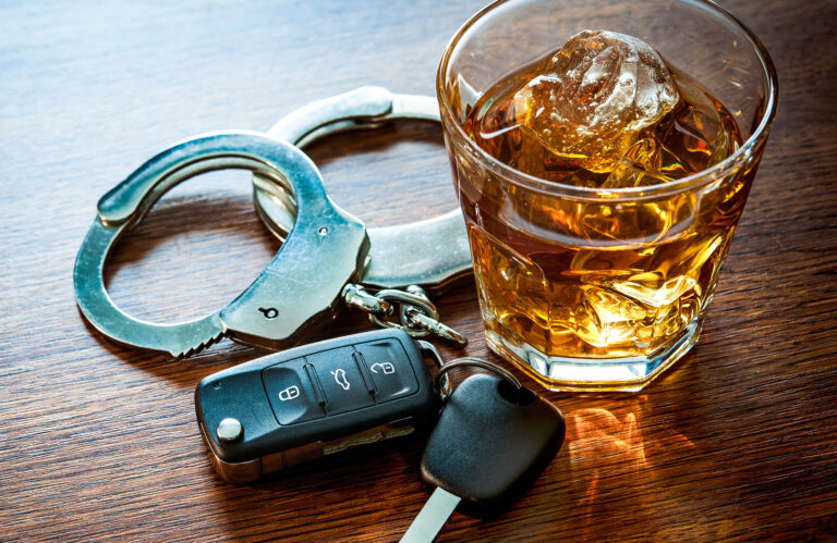 A photo of car keys, an alcoholic drink, and handcuffs. - April is DUI Awareness Month. Don't Drink and Drive!